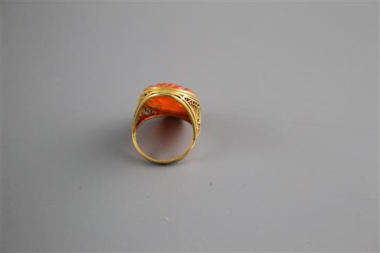 A 14k filigree yellow metal and orange chalcedony set dress ring, carved with fruit, size M, gross weight, 6 grams.